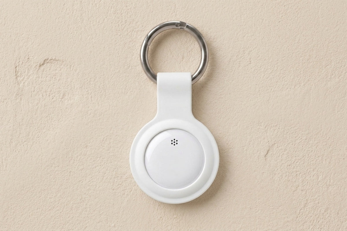Bluetooth key tracker in a white keychain holder